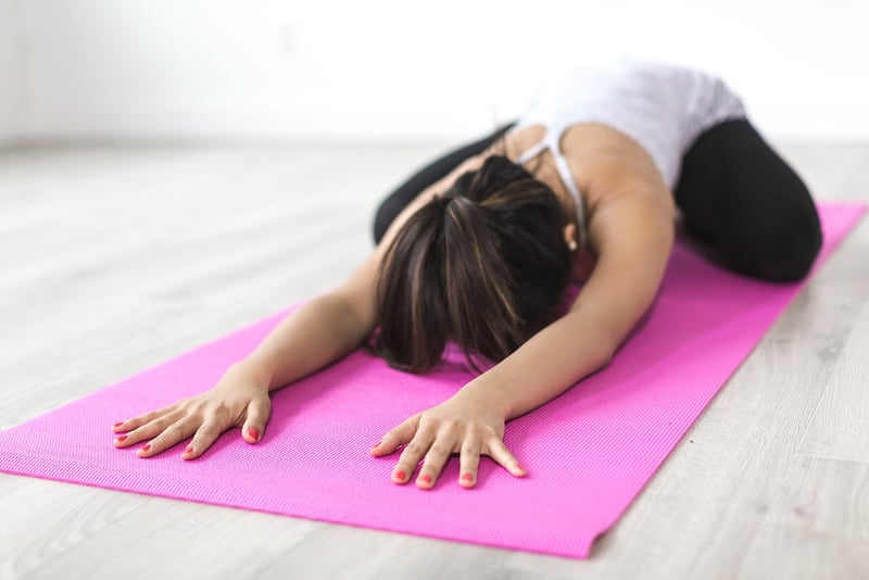 Woman practicing yoga by the sea